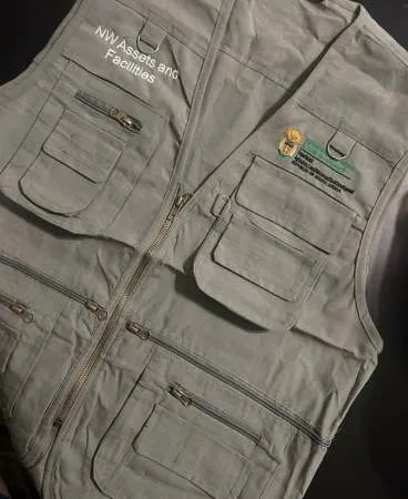 A close-up of a khaki work jacket with reinforced pockets.